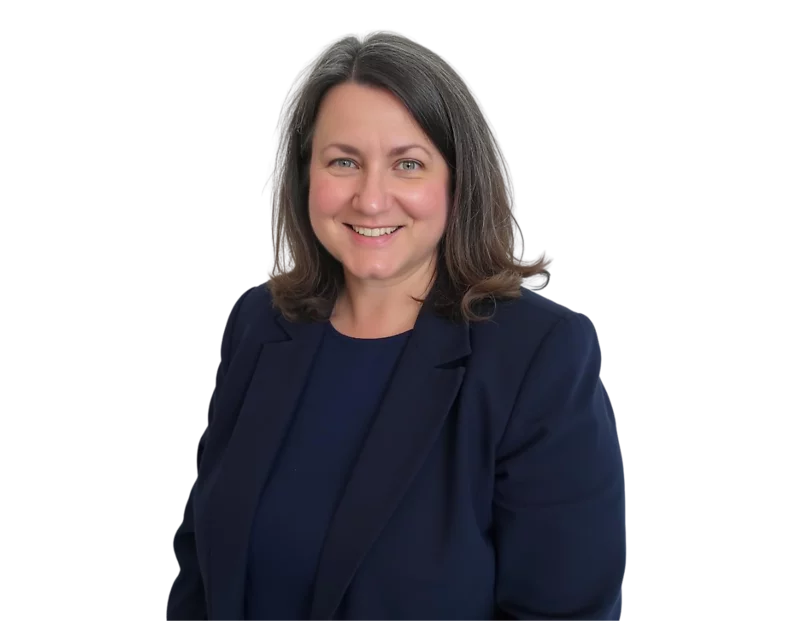 Laura Balson wearing a navy blazer over a matching navy top, posed against a light blue and white geometric background.