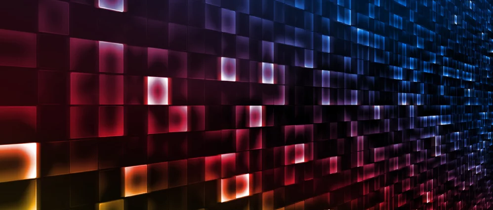 Abstract technology background featuring a grid of glowing square tiles in red, blue, and purple tones. The illuminated blocks create a dynamic pattern with depth and motion across the surface.