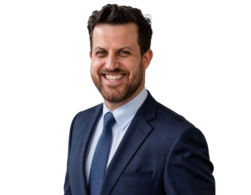 Jason Friedman in a dark navy suit and tie smiles against a light blue and white geometric background.