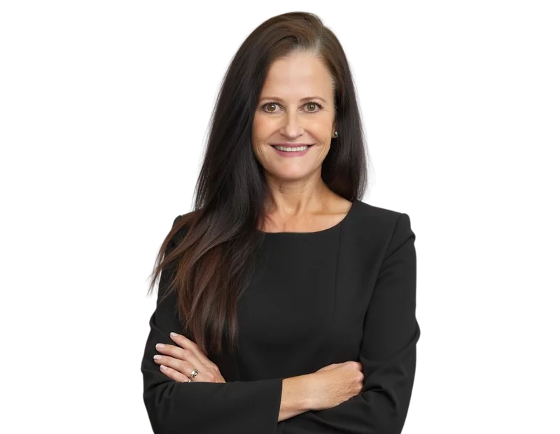 Professional photo of Kelly Holbrook wearing a black dress, smiling with arms crossed.