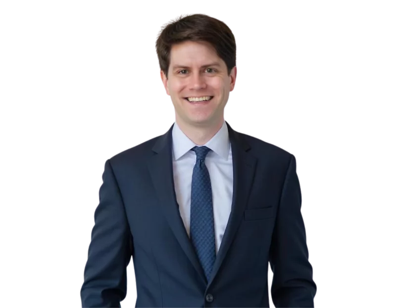 Matthew Clark, a labor and employment attorney, smiling in a navy blue suit with a patterned tie against a plain background. His professional appearance conveys approachability and expertise in workplace legal matters.