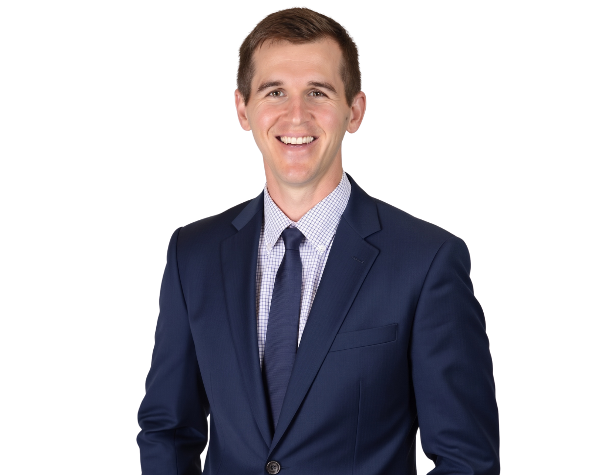 Bret Nyquist, wearing a navy suit, light blue checkered dress shirt, and navy tie, smiles at the camera.