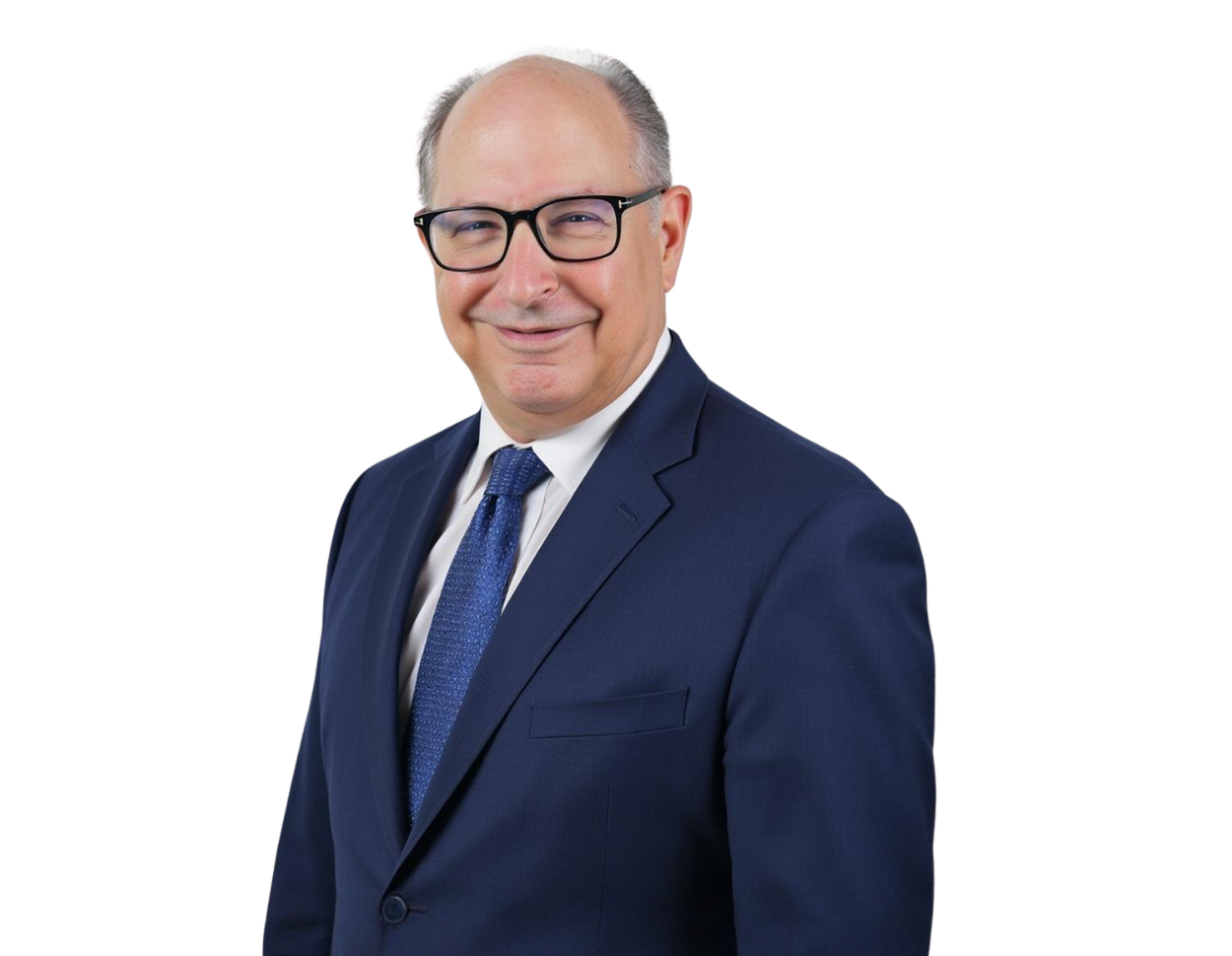 Remy Kessler smiling in a formal headshot. He is wearing a dark blue suit, white shirt, and textured blue tie, posed against a plain background.
