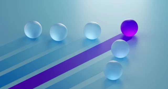 Blue and purple marbles with one in the lead
