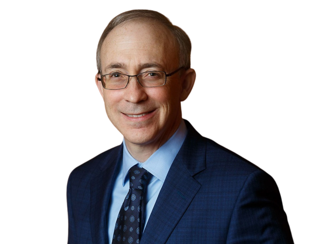 Eric Proser wearing glasses, a blue suit, light blue shirt, and patterned dark tie against a plain background.