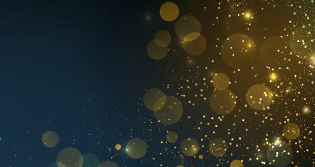 Gold shiny dots in front of dark background, bokeh lights