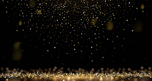 Black background with Gold glitter falling from the ceiling and collecting at the bottom