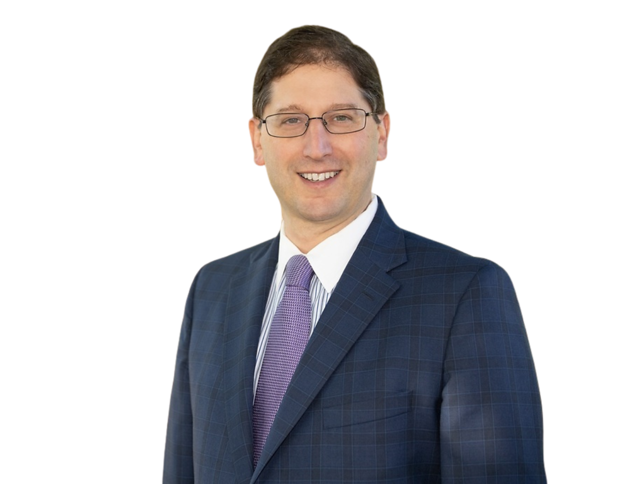Professional headshot of a smiling Justin Coffey in a blue checkered suit and purple tie.