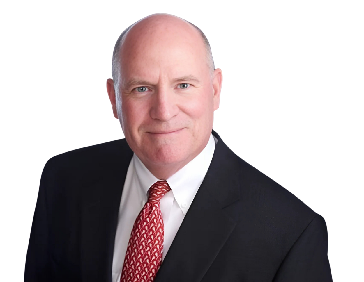 A middle-aged man with a bald head smiles slightly while wearing a black suit, white dress shirt, and red patterned tie. The background has been removed, highlighting him in a clean, professional headshot.