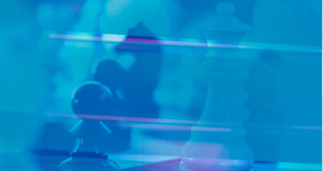 “Abstract image of a chessboard with blurred chess pieces, including a white queen and a pawn, overlaid with a blue filter and streaks of light.
