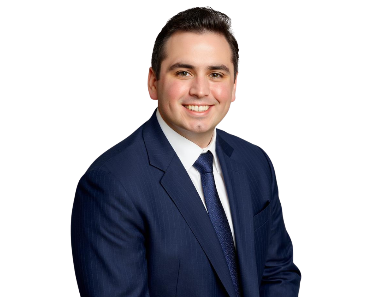 Smiling professional man with short dark hair wearing a navy blue suit, white dress shirt, and textured blue tie, posed against a transparent background. His polished appearance and friendly expression make the image suitable for a corporate or executive