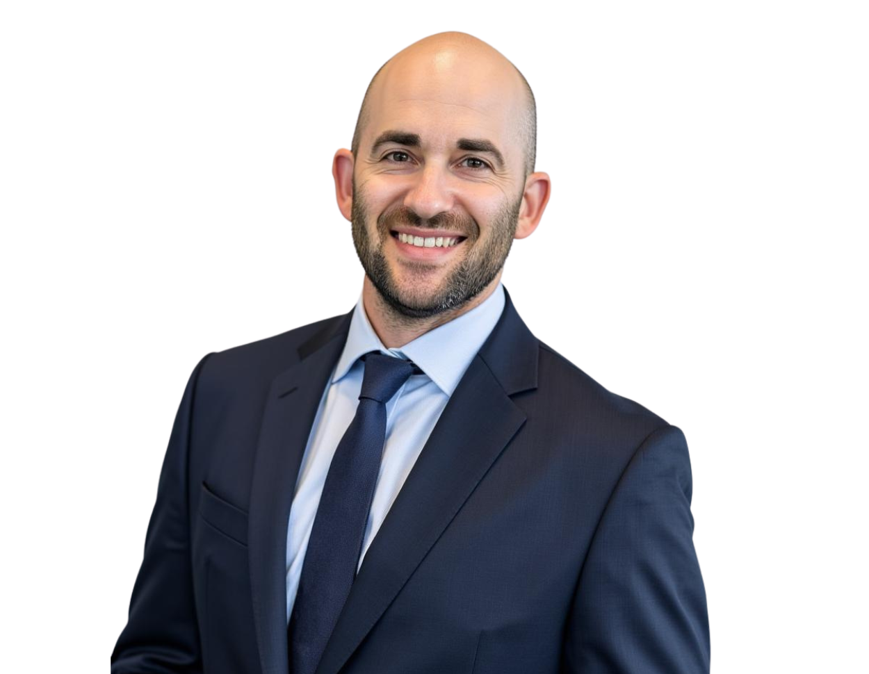 Jeffrey Fields in a dark suit and blue tie smiles while standing against a light blue and white geometric background.
