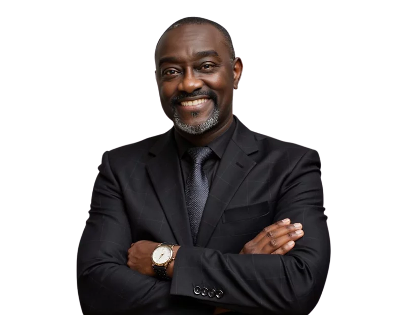 Professional headshot of Carl McCalla smiling slightly, wearing a dark pinstripe suit, white dress shirt, and a patterned blue tie.