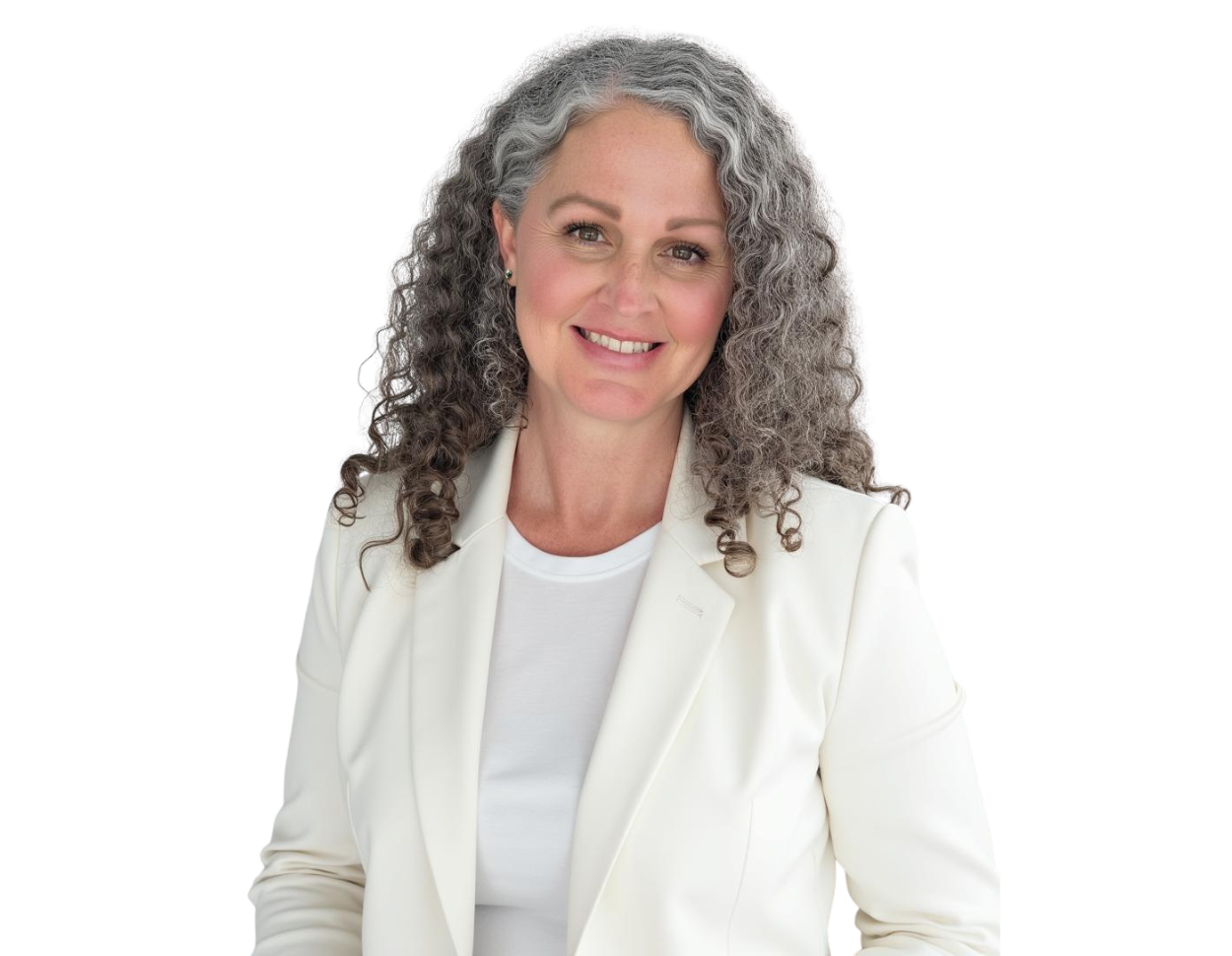 A woman with long, curly gray hair and a warm smile is wearing a white blazer over a white top. She is facing the camera with a confident and approachable expression, set against a transparent background.