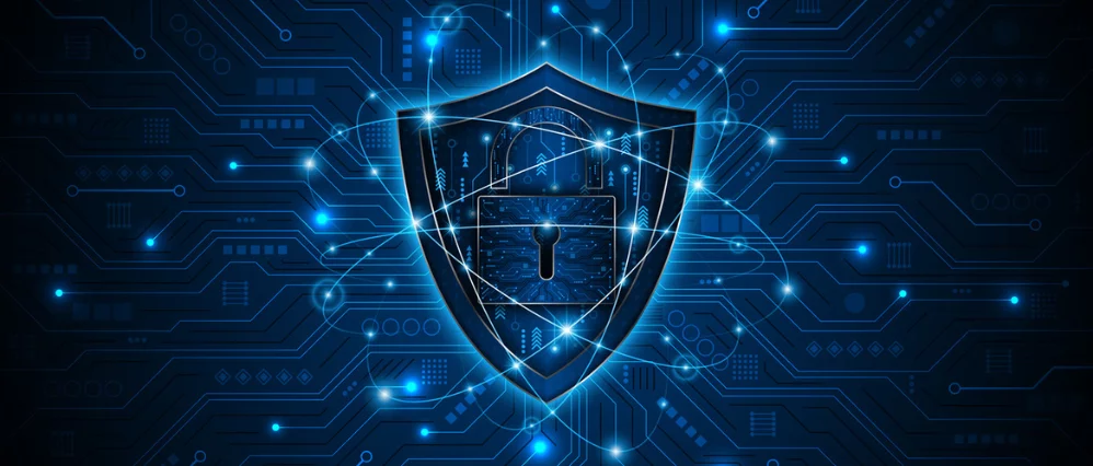 Digital illustration of a glowing shield with a central padlock icon set against a dark blue circuit board background. Bright interconnected lines and nodes radiate across the design, suggesting encrypted data and secure networks.