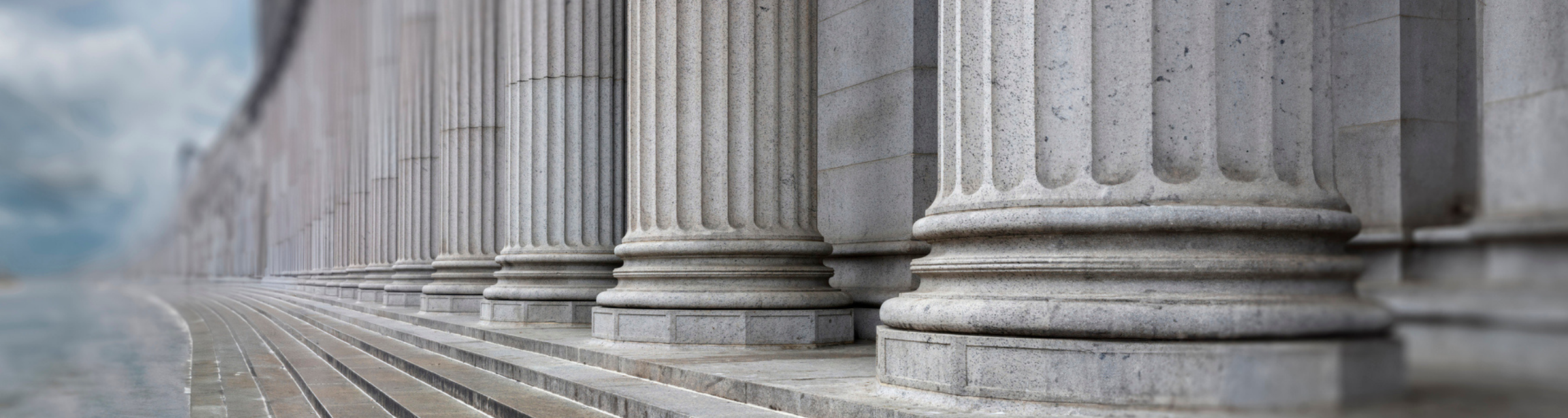 Stone colonnade and stairs detail. Classical pillars row in a building facade