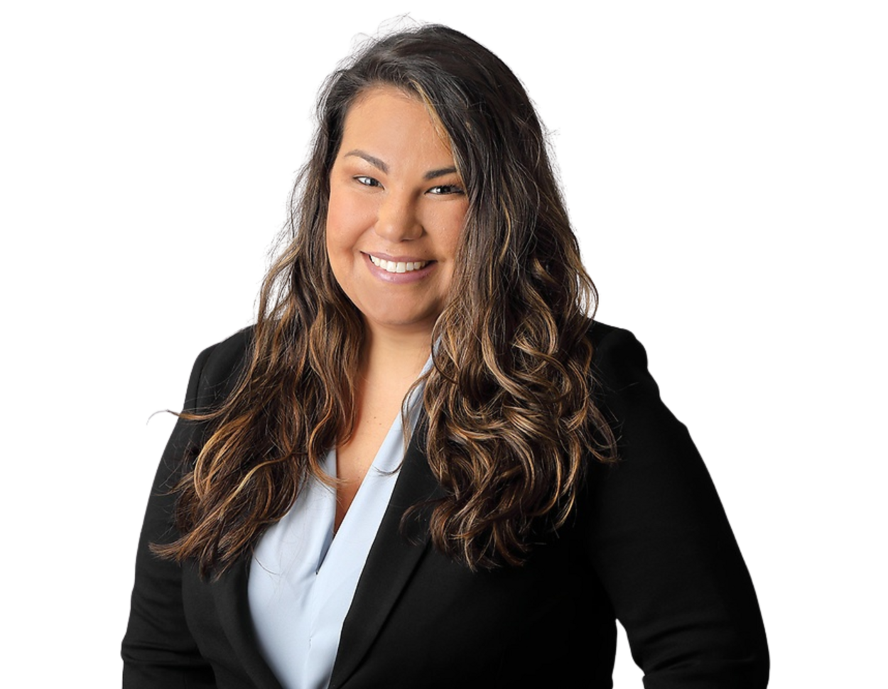 Professional headshot of Amanda Morejon smiling, wearing a light blue blouse under a black blazer, with long wavy hair, posed against a softly blurred light background.