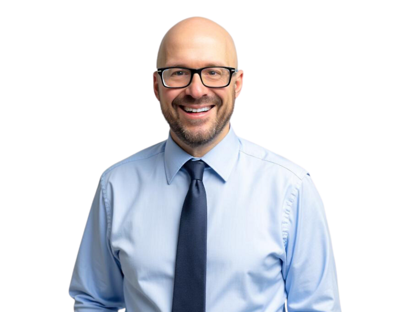 Dave Kurtz in a blue shirt and tie, smiling in front of a light geometric background.