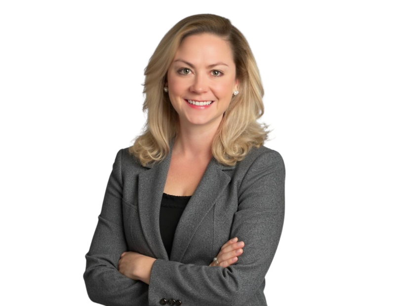 Professional headshot of Anna Schall Kreamer, Senior Counsel of the Constangy Cyber Team. She is smiling confidently with arms crossed, wearing a grey blazer over a black top, and has shoulder-length blonde hair styled in loose waves.