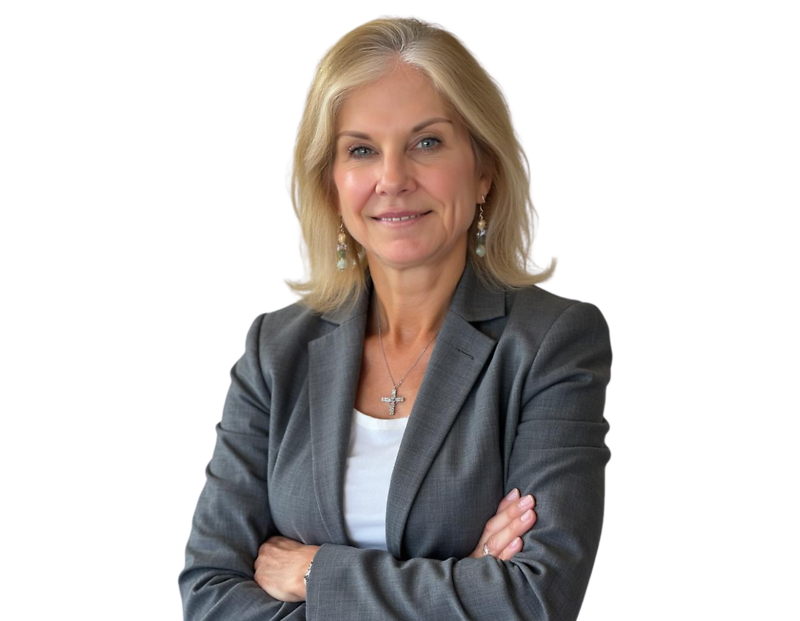 Lauren Godfrey wearing a gray blazer over a white top, accessorized with a cross necklace and drop earrings, arms crossed, posed against a light blue and white geometric background.