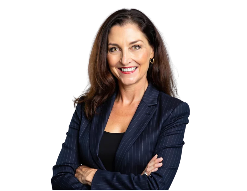 Professional of Jackie Johnson wearing a navy pinstripe blazer and black top, smiling confidently with arms crossed. She stands against a transparent background, giving a polished and approachable look suitable for business or leadership contexts