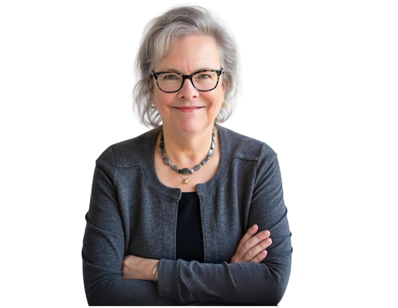 Smiling older woman with short gray hair and glasses, wearing a dark gray cardigan over a black top and a beaded necklace, with arms confidently crossed. She has a warm, approachable demeanor and a professional presence against a transparent background.