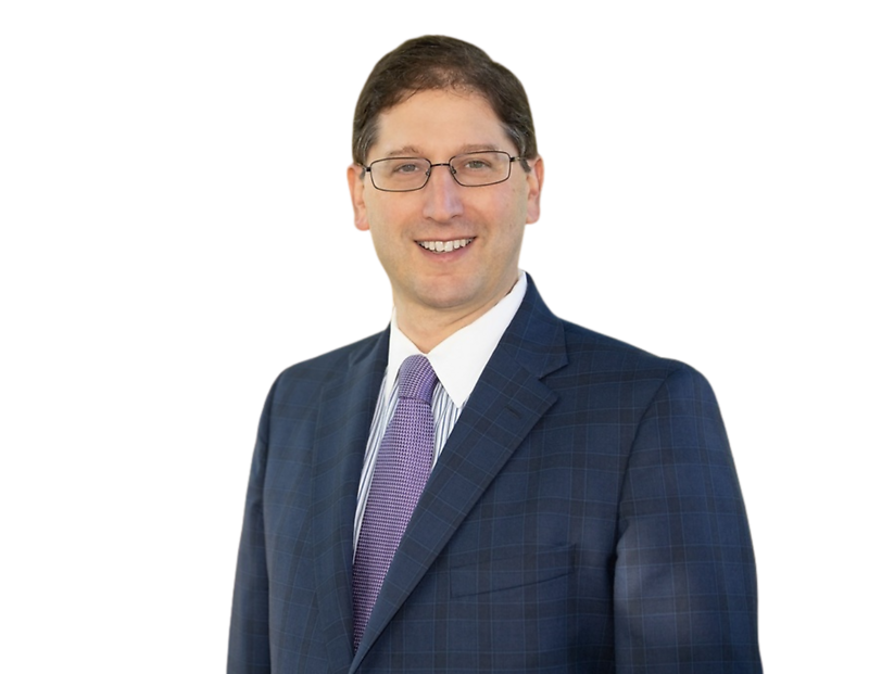 Professional headshot of a smiling Justin Coffey in a blue checkered suit and purple tie.