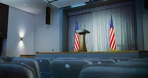 Press campaign room with seats and American flags stock photo