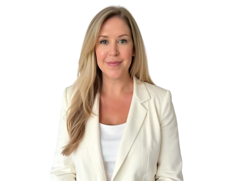 Smiling woman with long blonde hair wearing a white pinstripe blazer over a white top, posed against a plain white background. She has a professional yet approachable look, with minimal makeup and soft waves in her hair.
