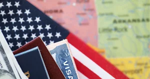 Visa with flag and US passport against a map of America.